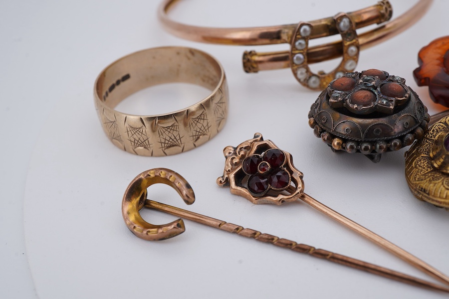 A collection of stick pins, bangle and ring, comprising: a 9ct gold and seed pearl bangle centring on a horseshoe motif, British hallmarks, gross weight 5 grams; a 9ct gold wide band ring, British hallmarks, gross weight